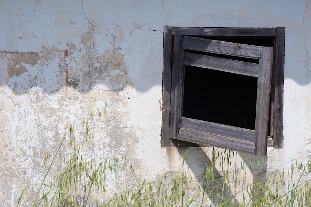 brown wooden window frame on white concrete wall