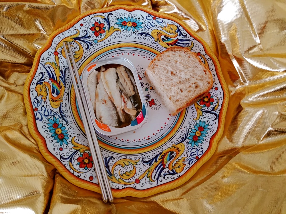 bread on white and blue floral ceramic plate