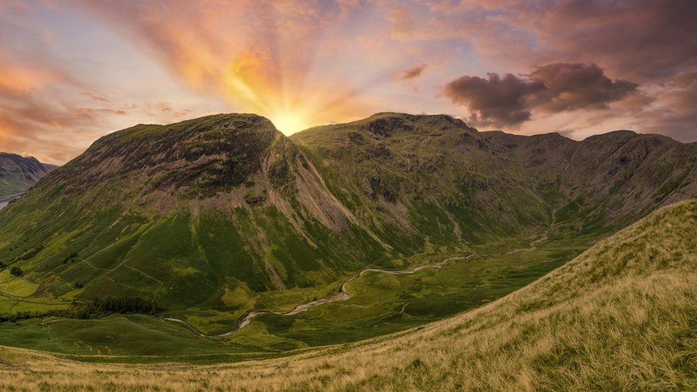 green and brown mountain under cloudy sky during daytime