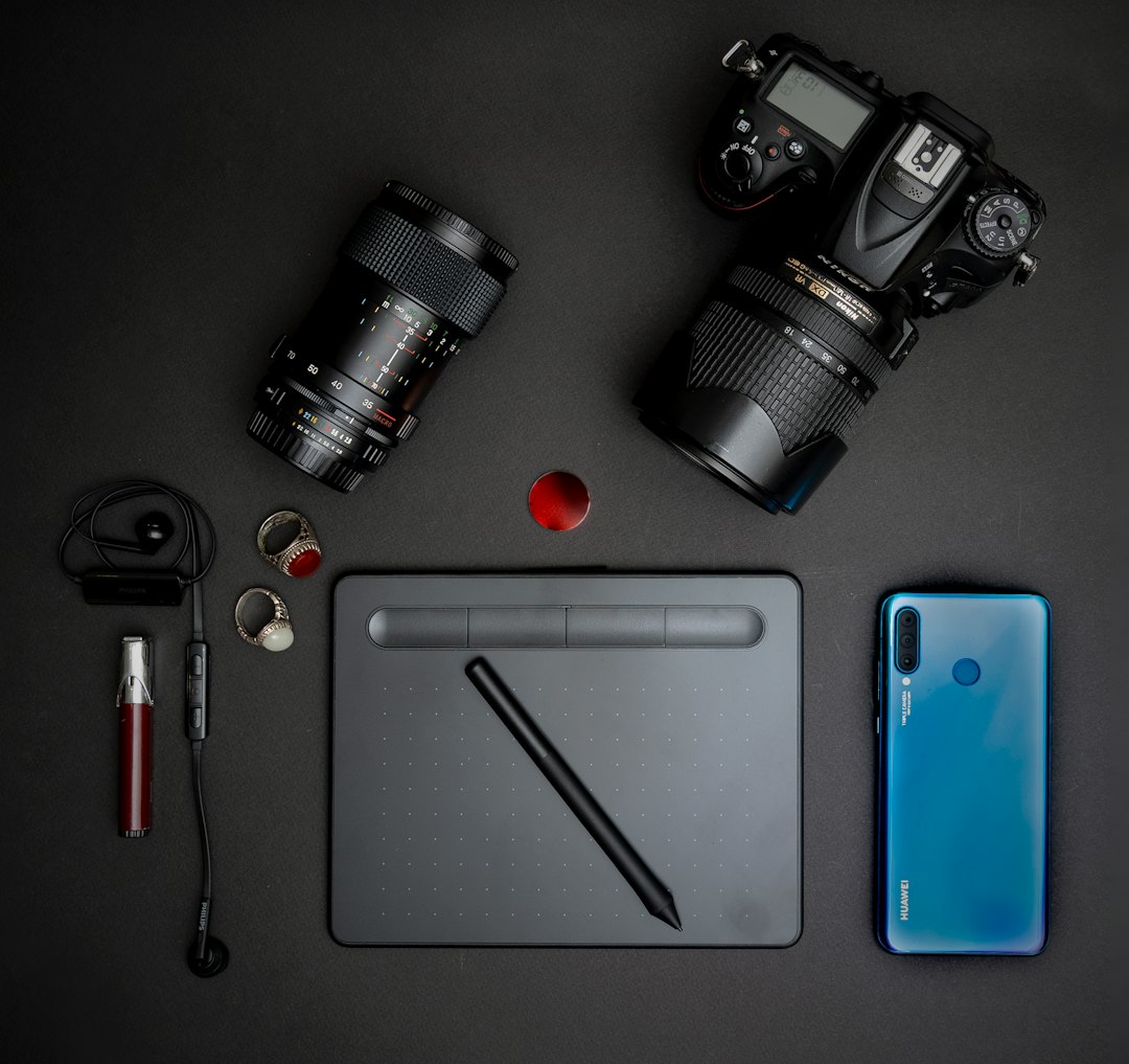 black dslr camera beside blue iphone 5 c