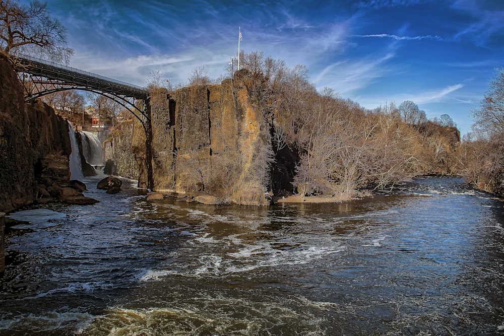 brown concrete building near river under blue sky during daytime