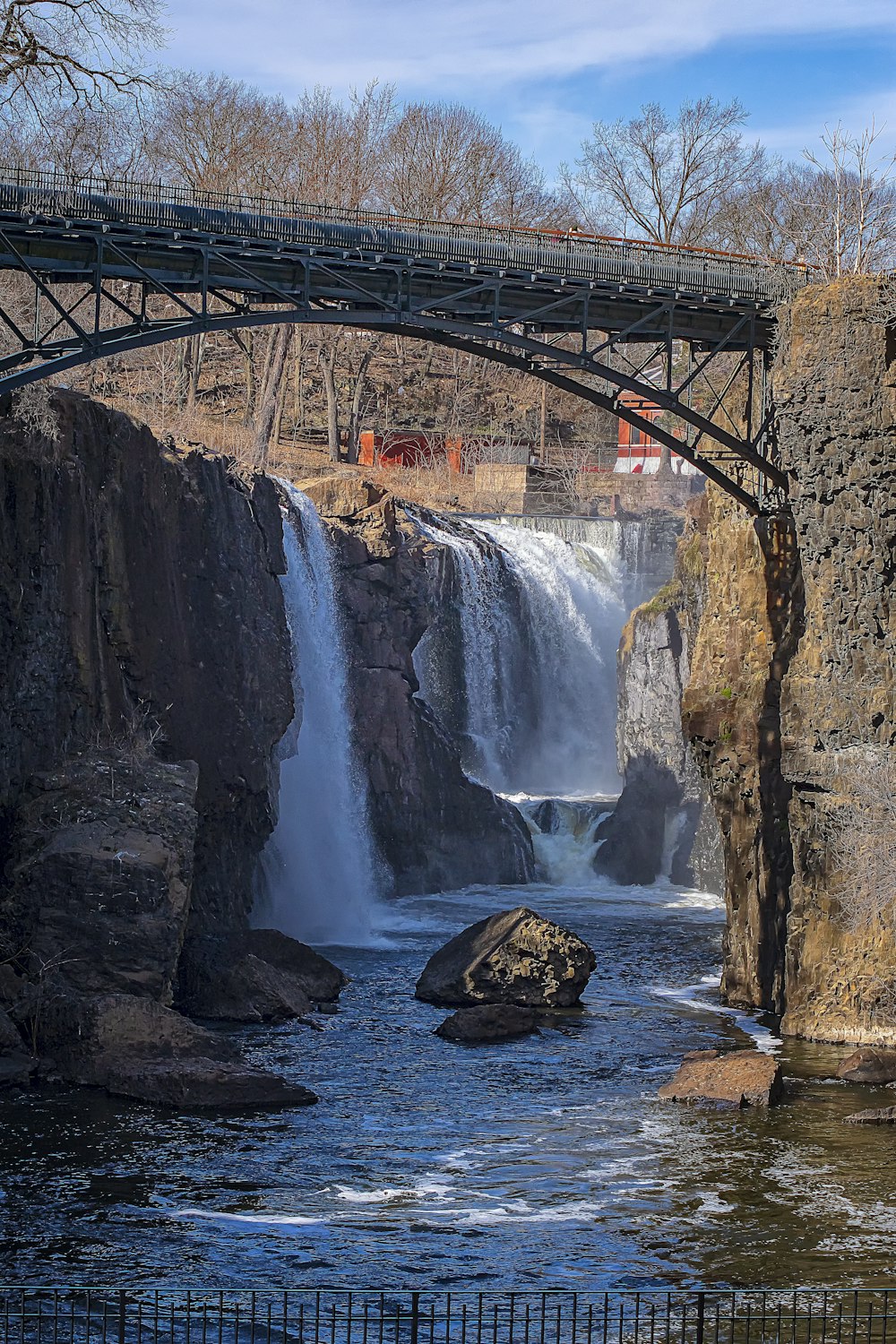 brown rock formation near waterfalls during daytime