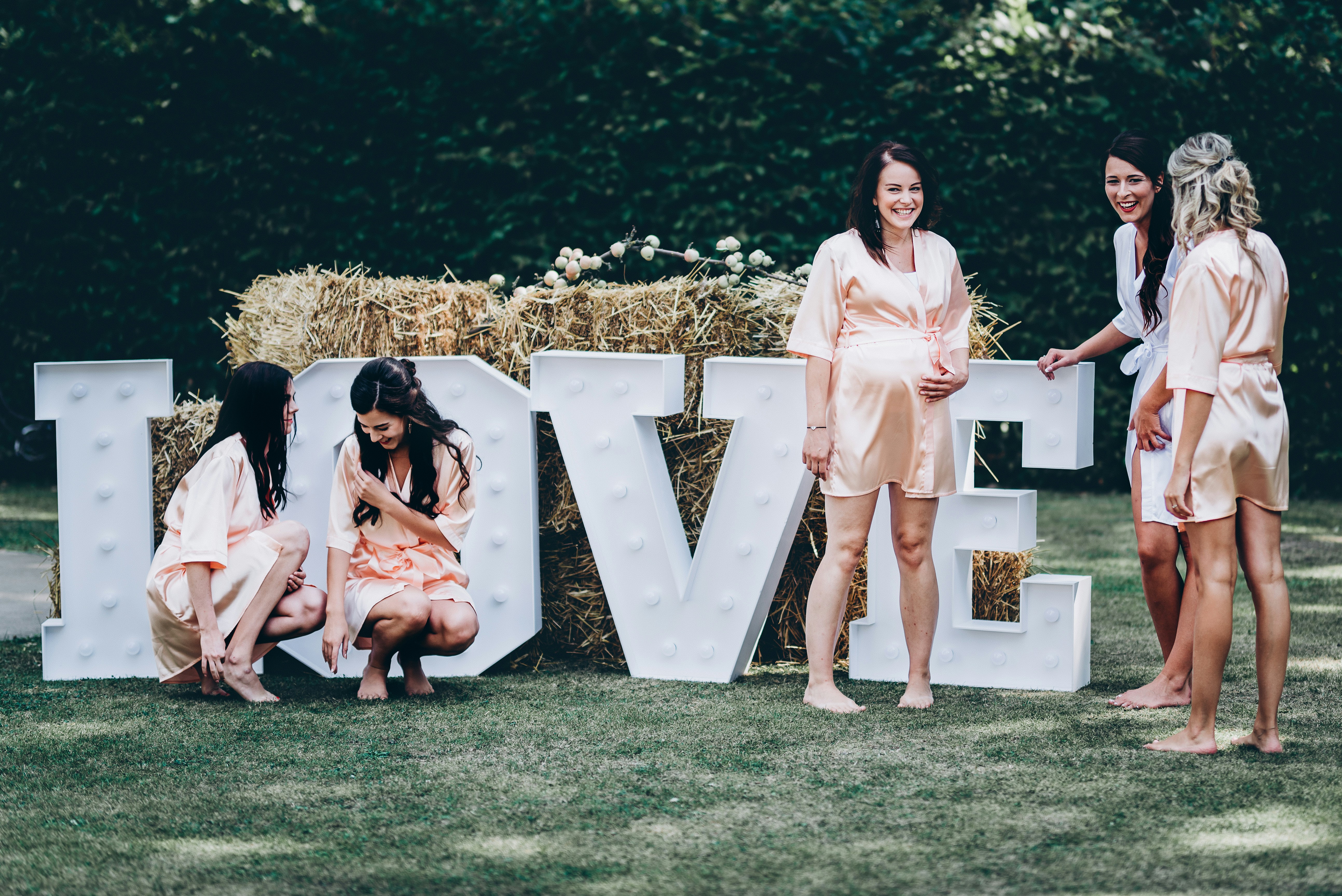 Guests laughing around a table at a bridal shower game
