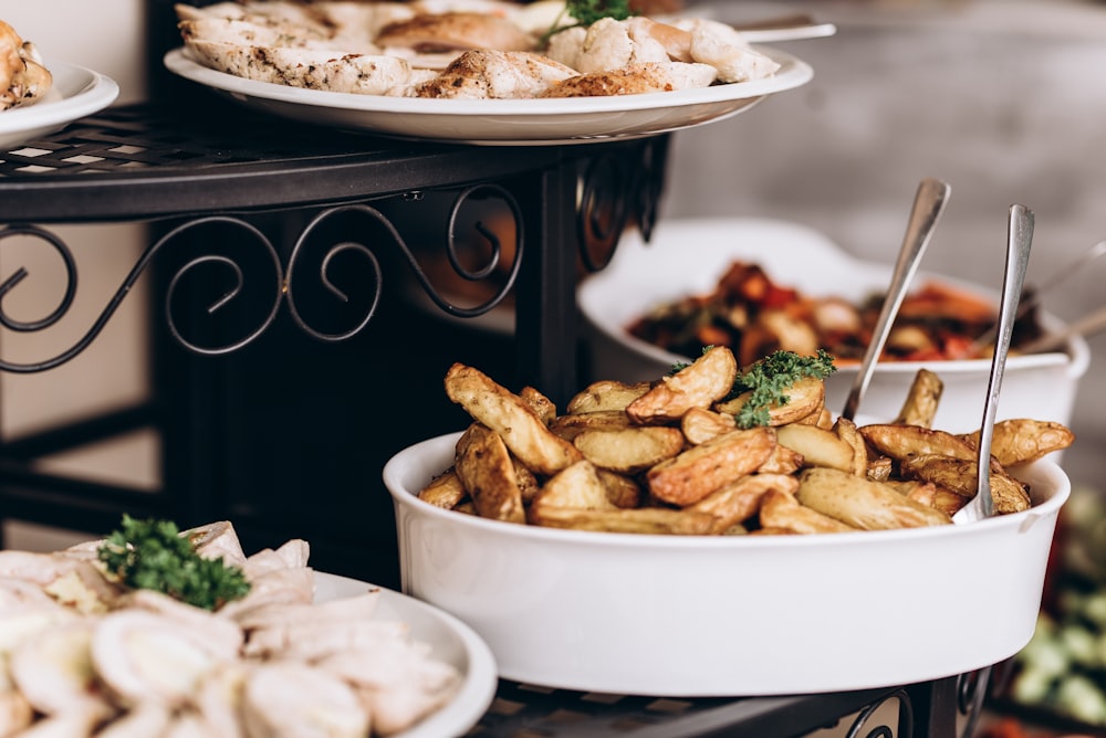 a table topped with plates of food and a bowl of food