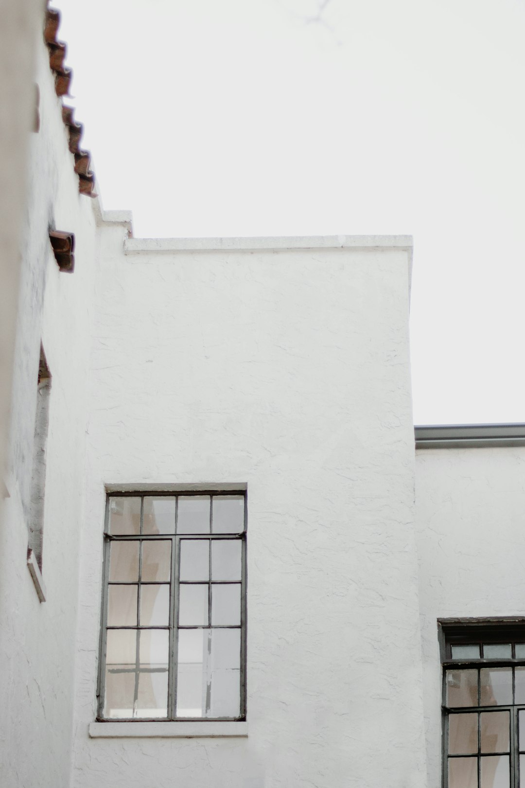 black metal window frame on white concrete wall