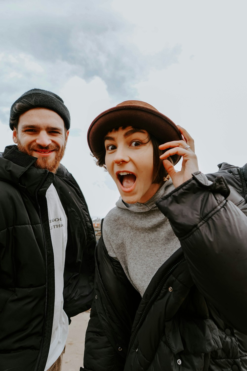 man in black jacket beside woman in black jacket