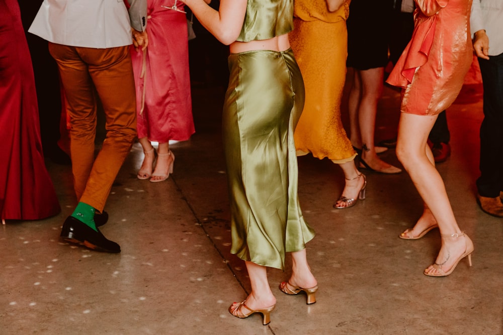 woman in green sleeveless dress standing on brown concrete floor