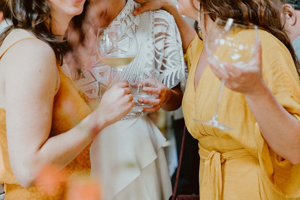 woman in white lace dress holding clear drinking glass