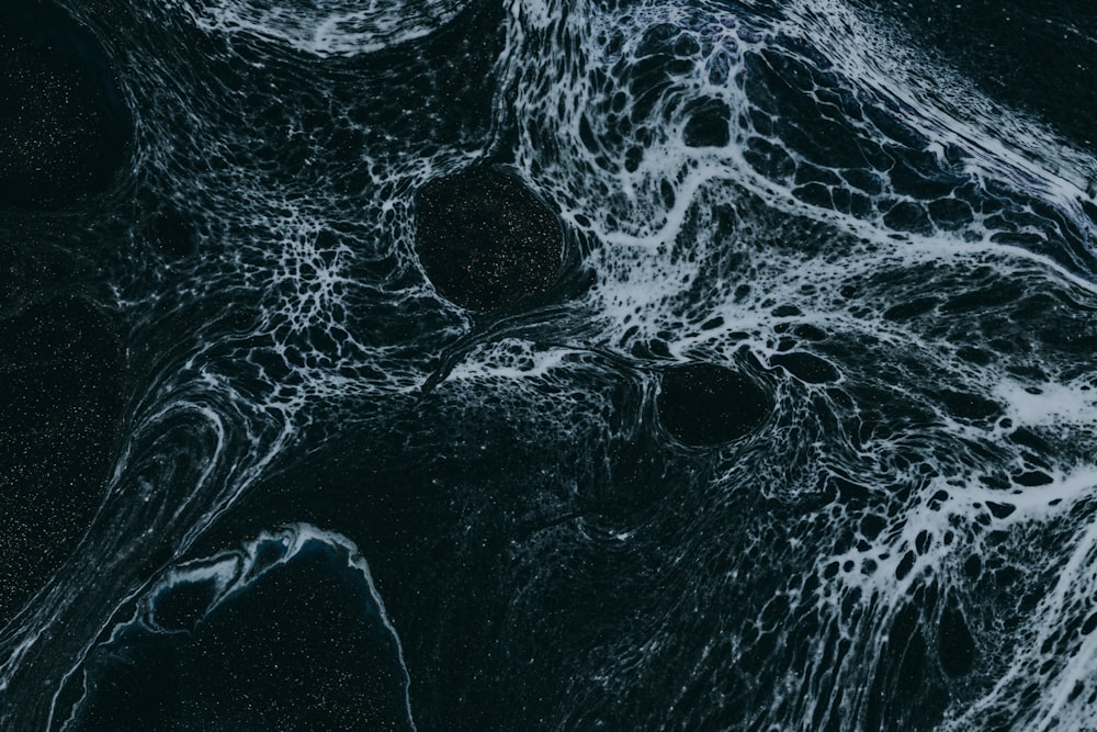 a black and white photo of water and rocks