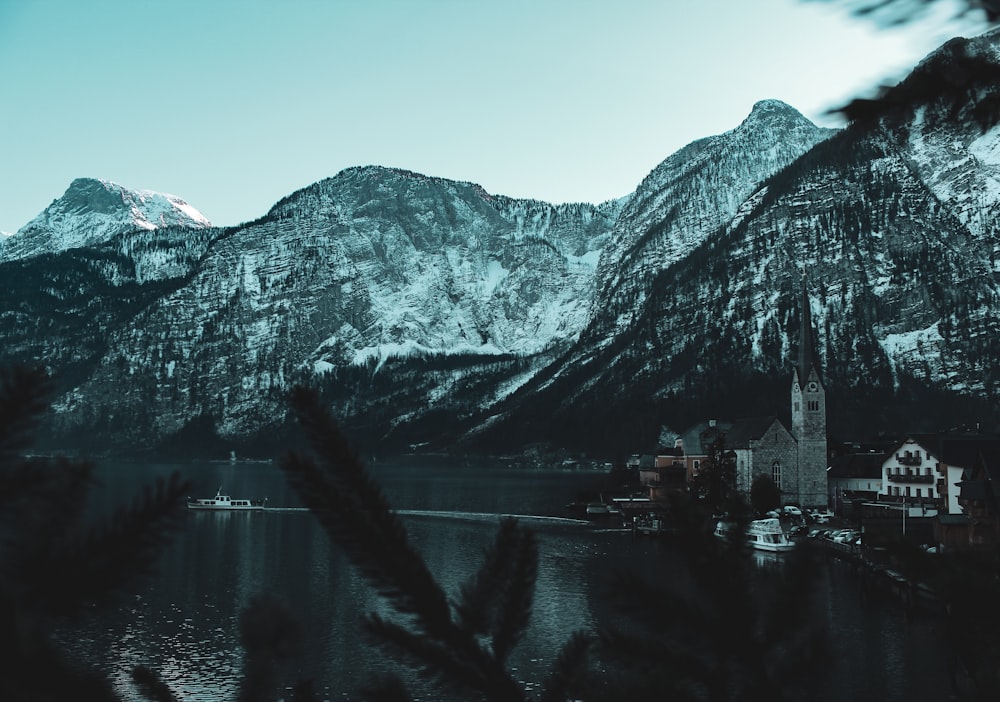 body of water near mountain during daytime