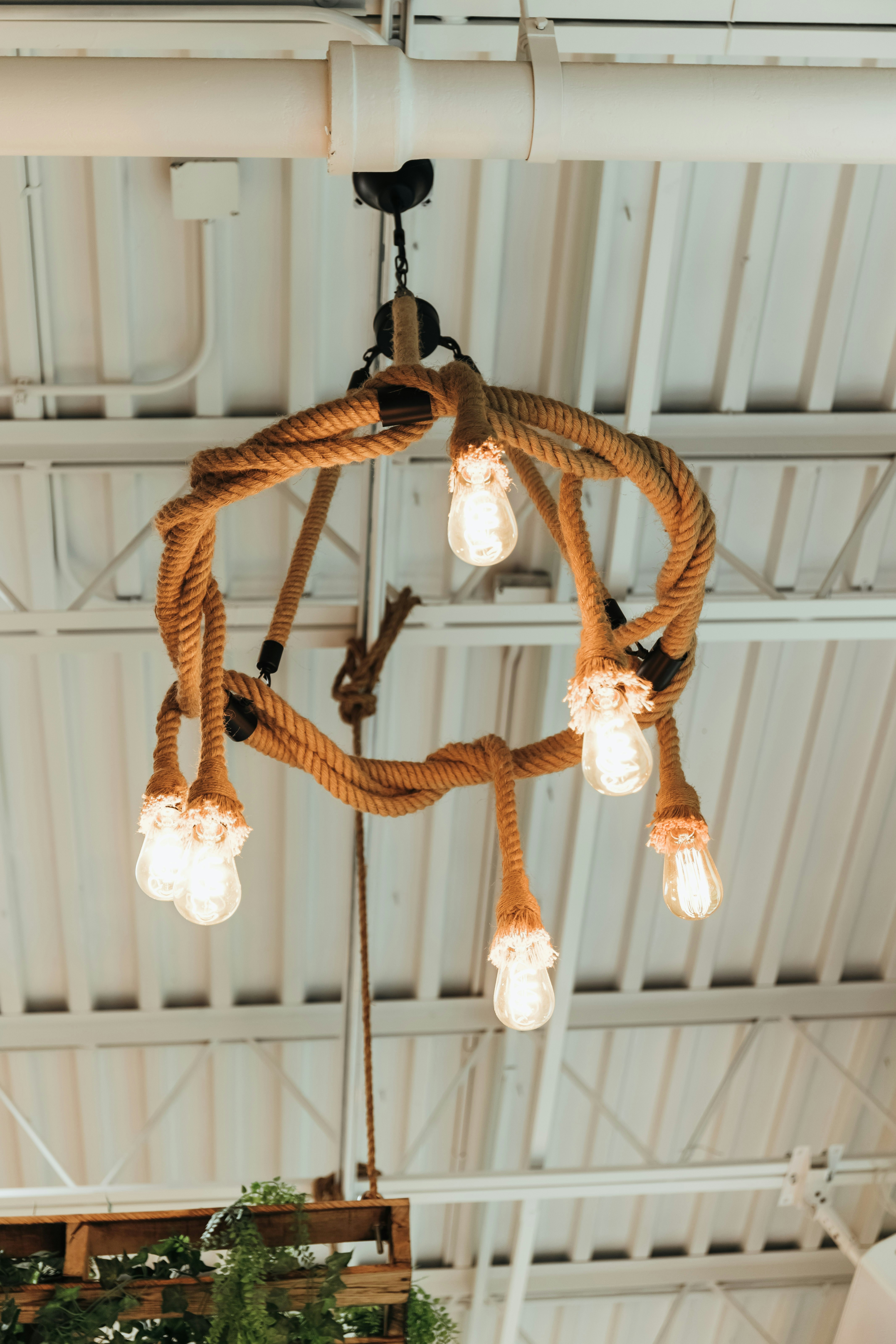 brown rope hanged on white metal bar