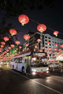 red and white bus on road during night time