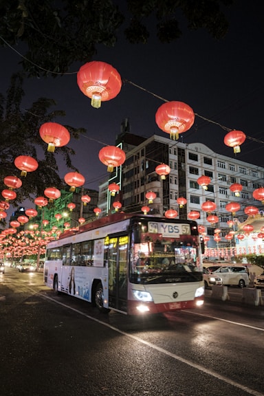 red and white bus on road during night time