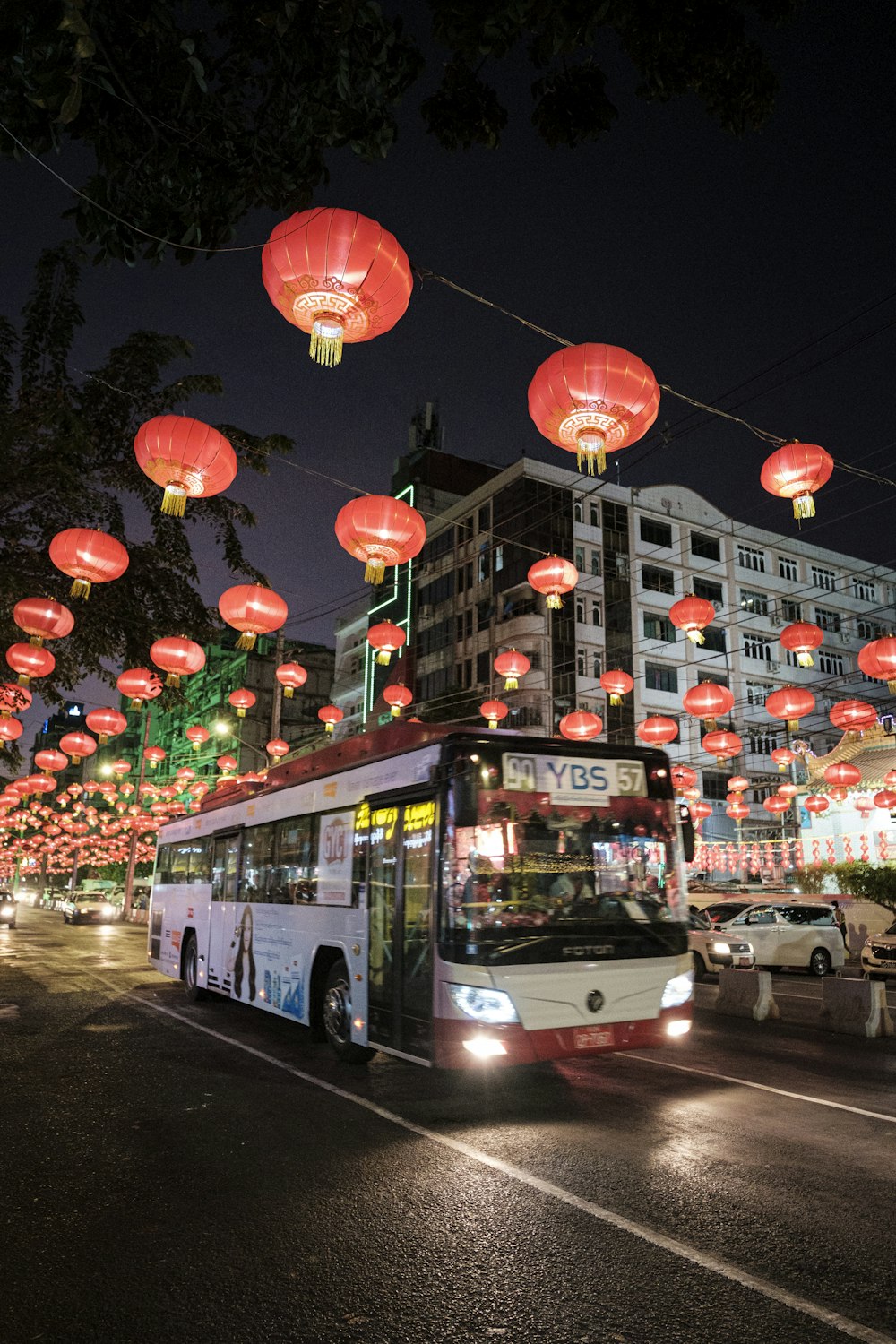 red and white bus on road during night time