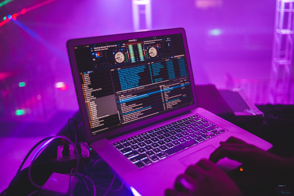 macbook pro on purple table