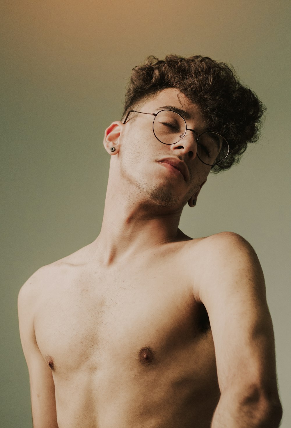 topless man wearing black framed eyeglasses