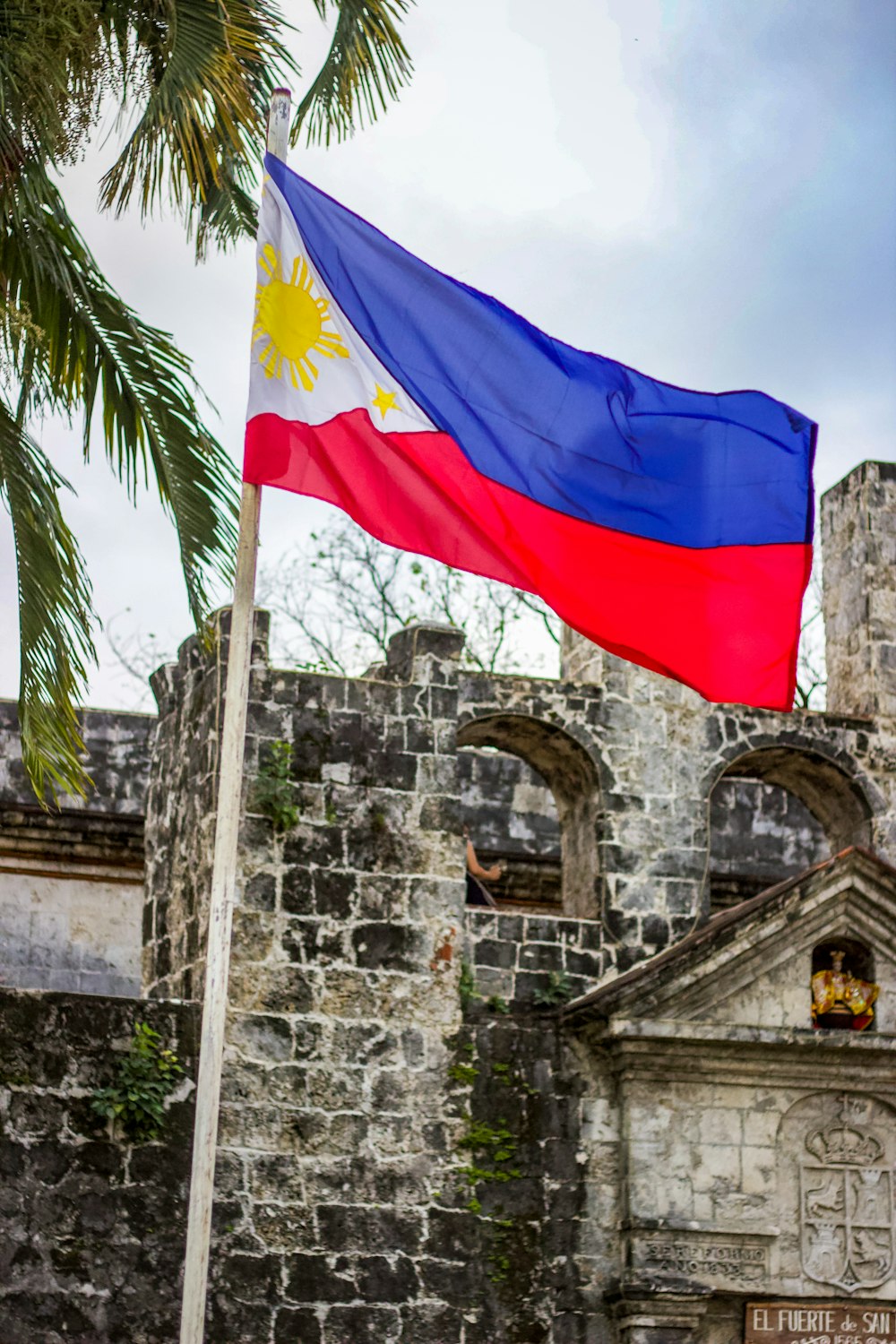 blue white and red flag on gray concrete wall