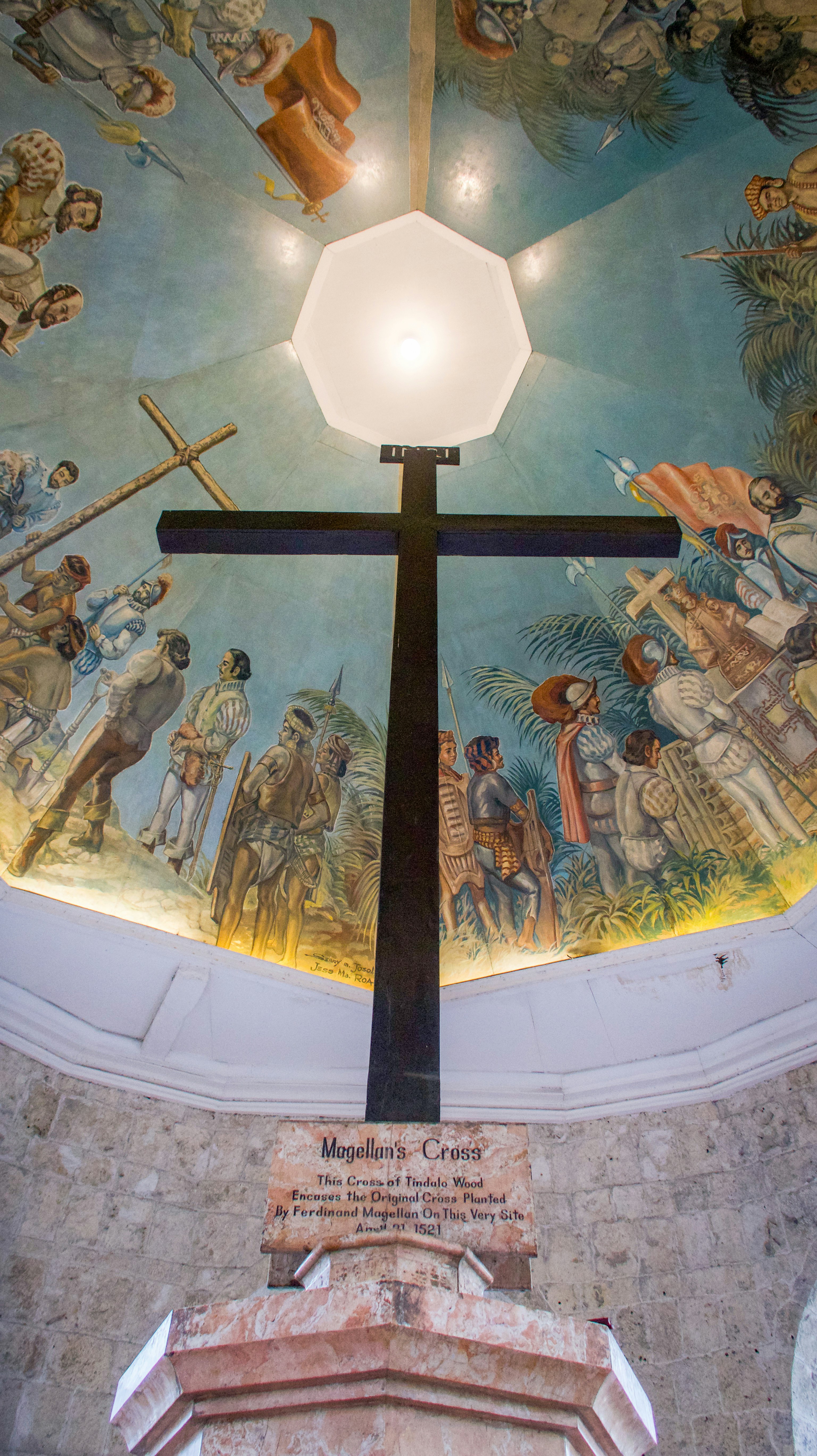 Magellan's Cross historic landmark in Cebu City with ornate ceiling paintings and tourists