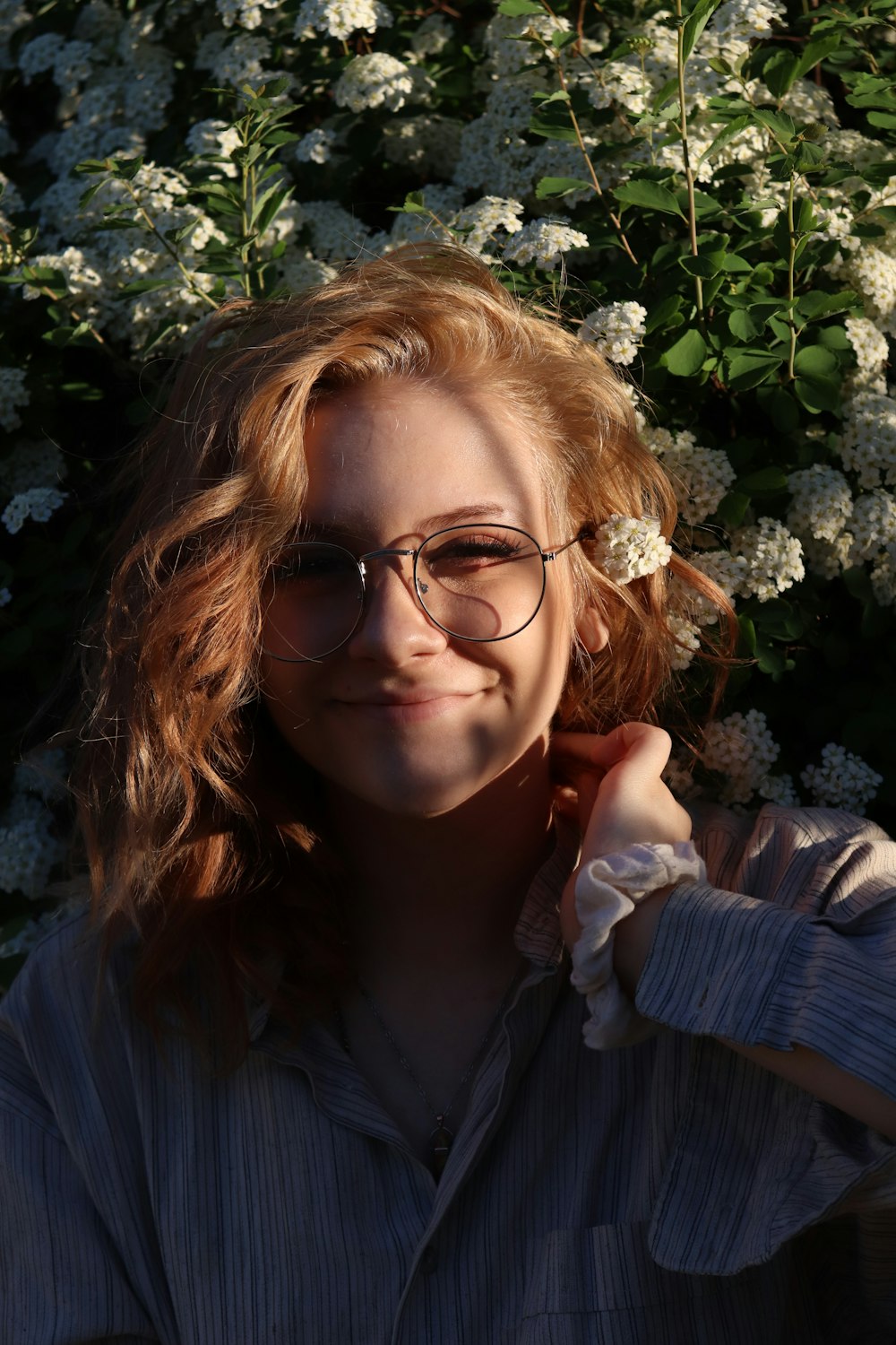 woman in blue jacket wearing eyeglasses