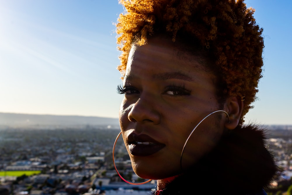 woman in red shirt wearing white earbuds