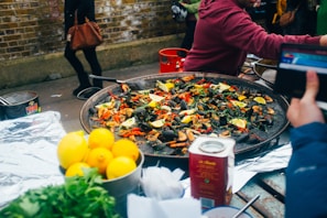 Colorful decorations and tables set for a paella feast.