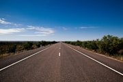 gray asphalt road under blue sky during daytime