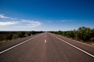 gray asphalt road under blue sky during daytime