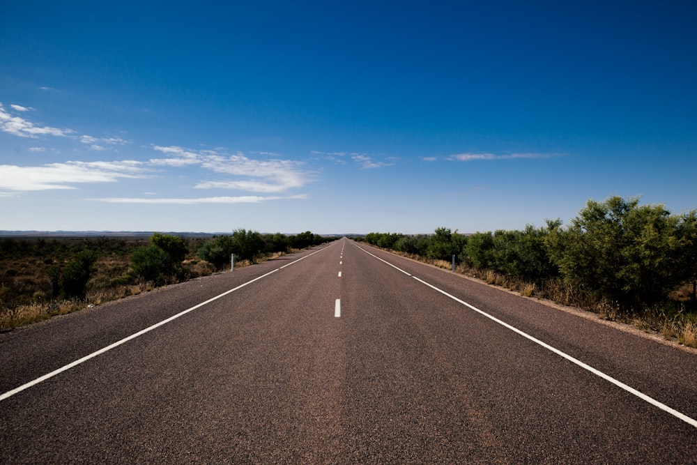 gray asphalt road under blue sky during daytime