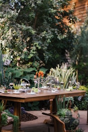 brown wooden table with chairs and plates