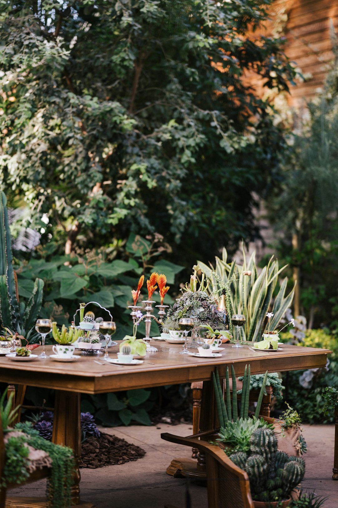 brown wooden table with chairs and plates