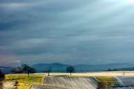 A peaceful white landscape under a cloudy sky, evoking calm.