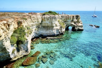 brown rock formation on blue sea during daytime