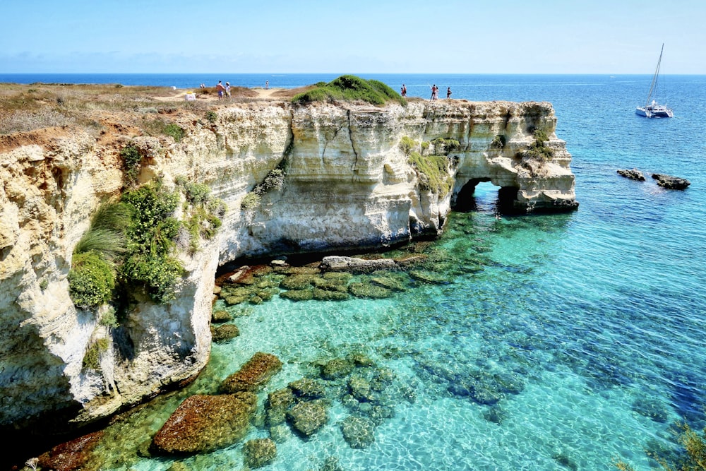 brown rock formation on blue sea during daytime