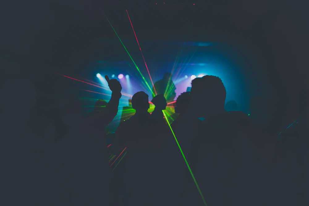 A silhouette holding a beam of blue light