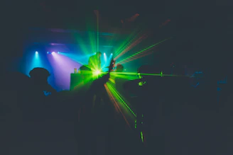 A vibrant party scene with colorful lights and a DJ engaging the crowd.