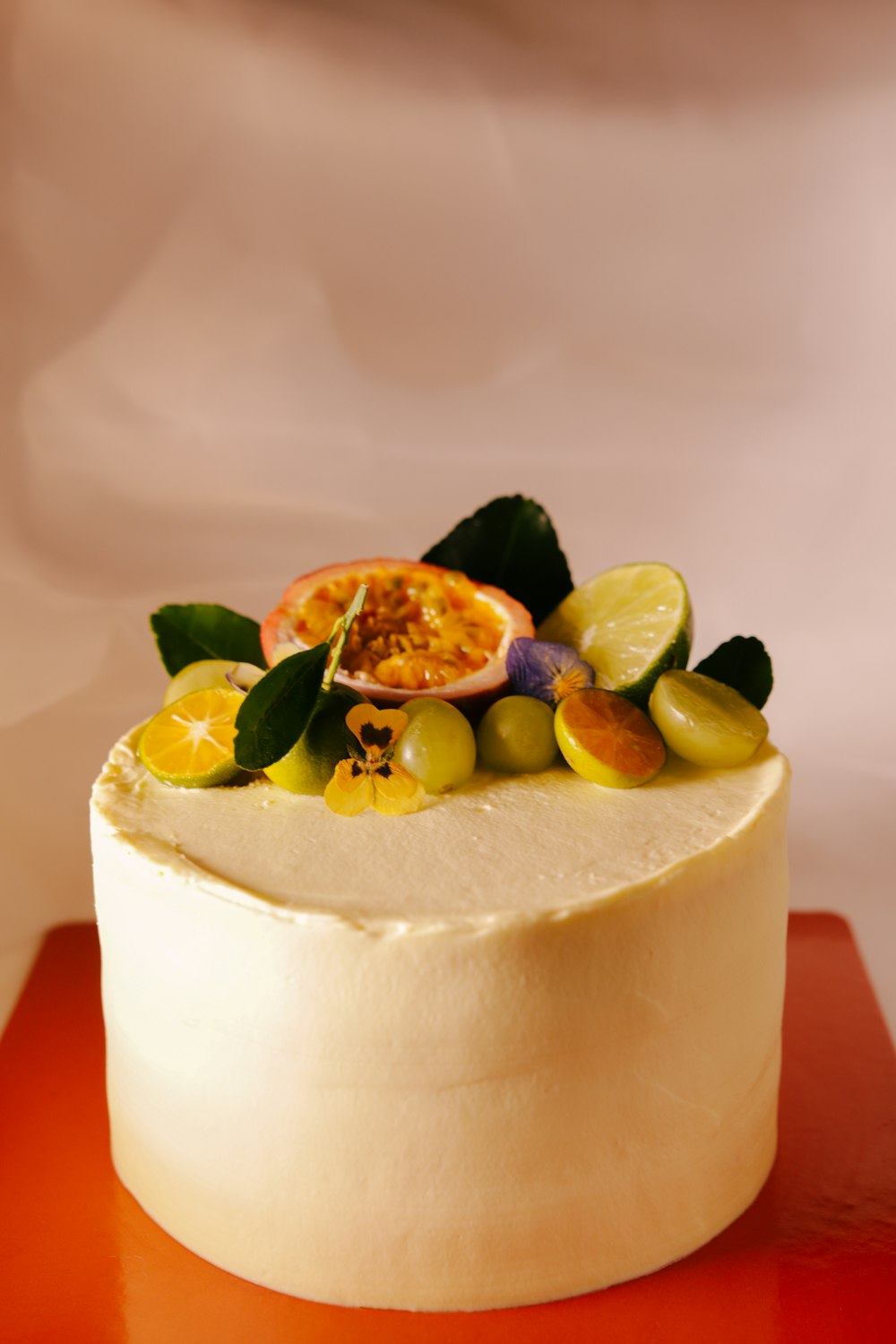 white cake with fruits on top