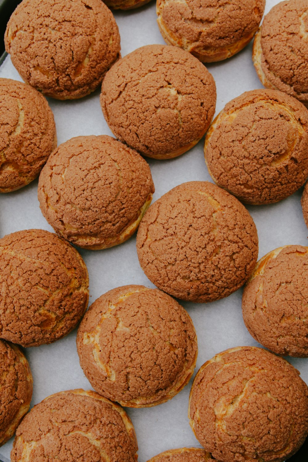 three brown cookies on white ceramic plate