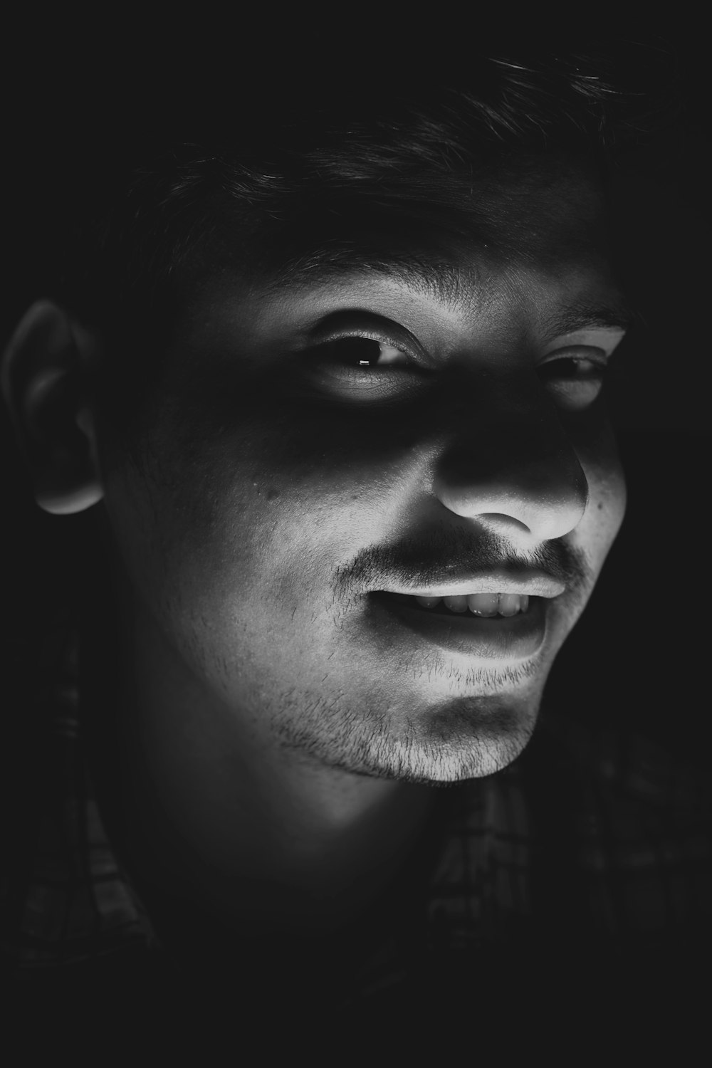 grayscale photo of smiling man