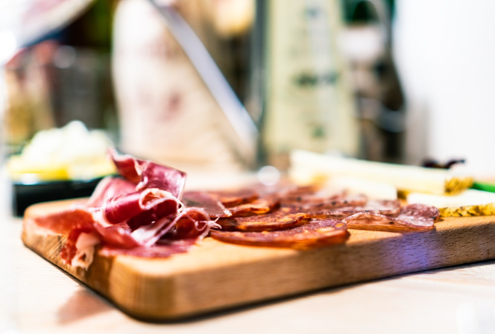 sliced pizza on brown wooden tray