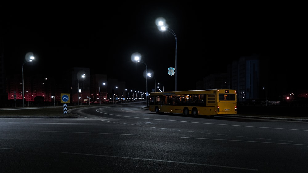 yellow bus on road during night time
