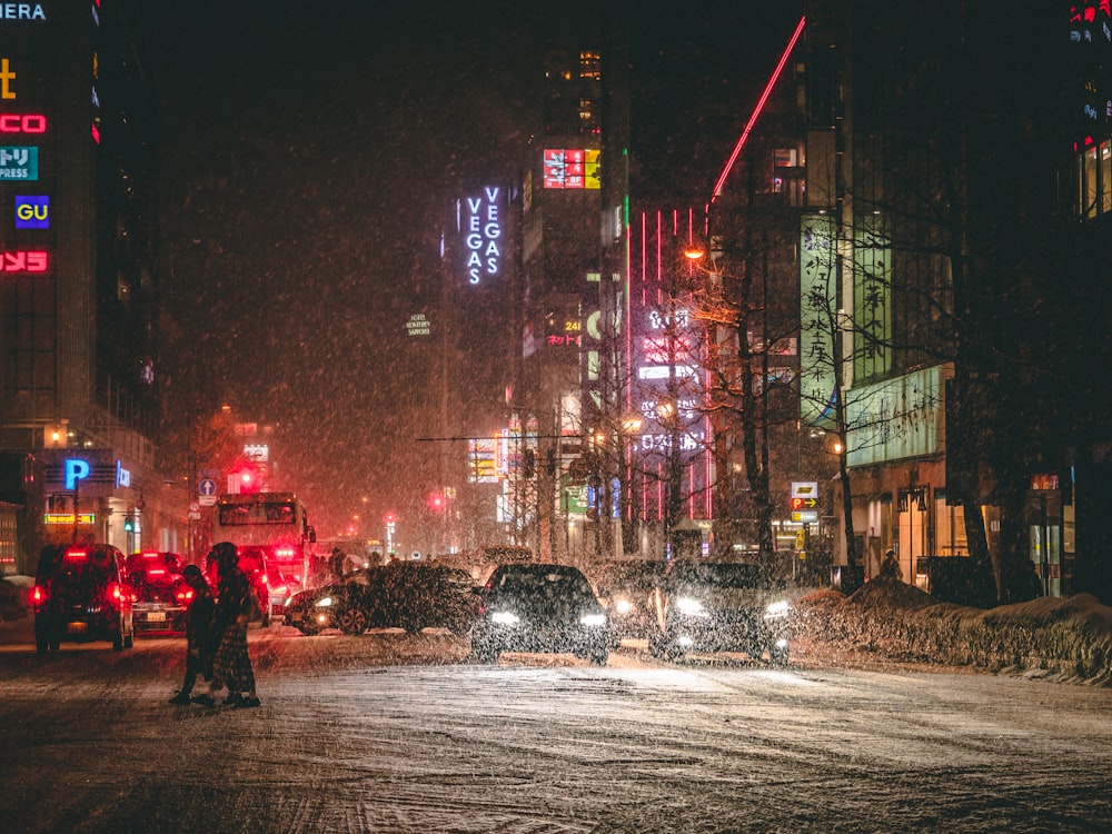 person in black jacket walking on street during night time