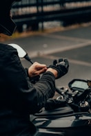 person in black jacket driving motorcycle