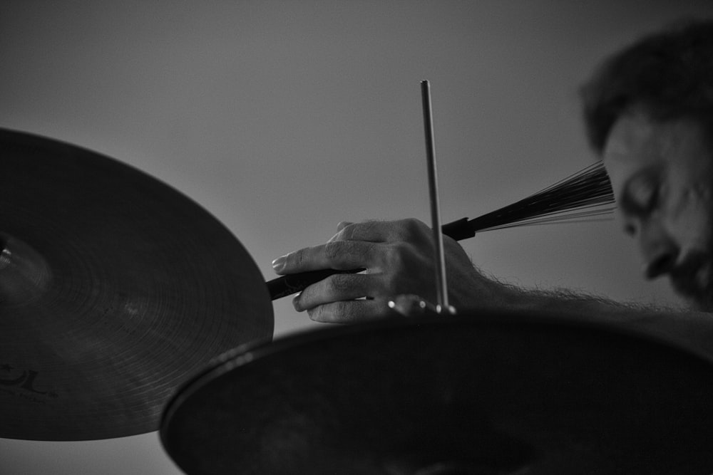 person holding a black and white drum stick