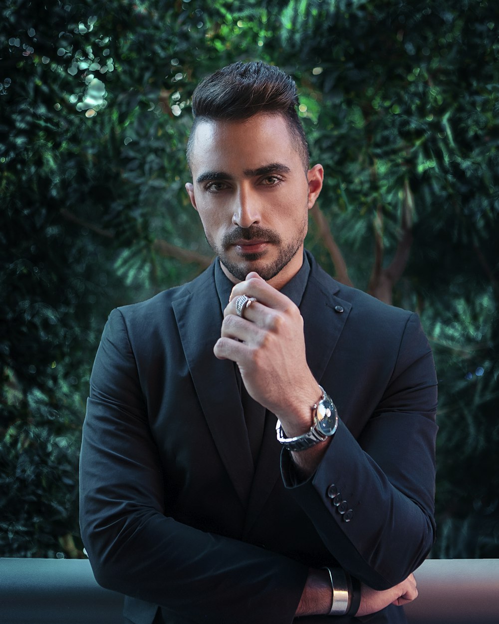 man in black suit jacket wearing silver ring