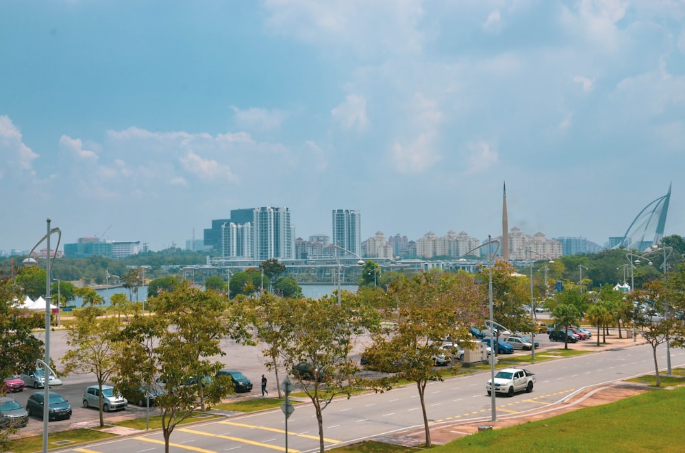 cars on road near city buildings during daytime