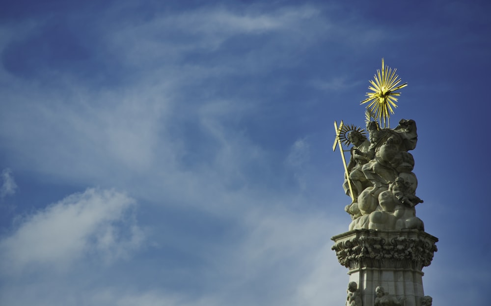 gray concrete statue under blue sky during daytime