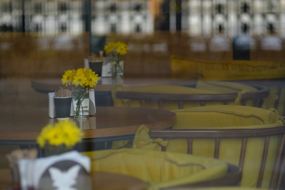 yellow flowers on brown wooden table