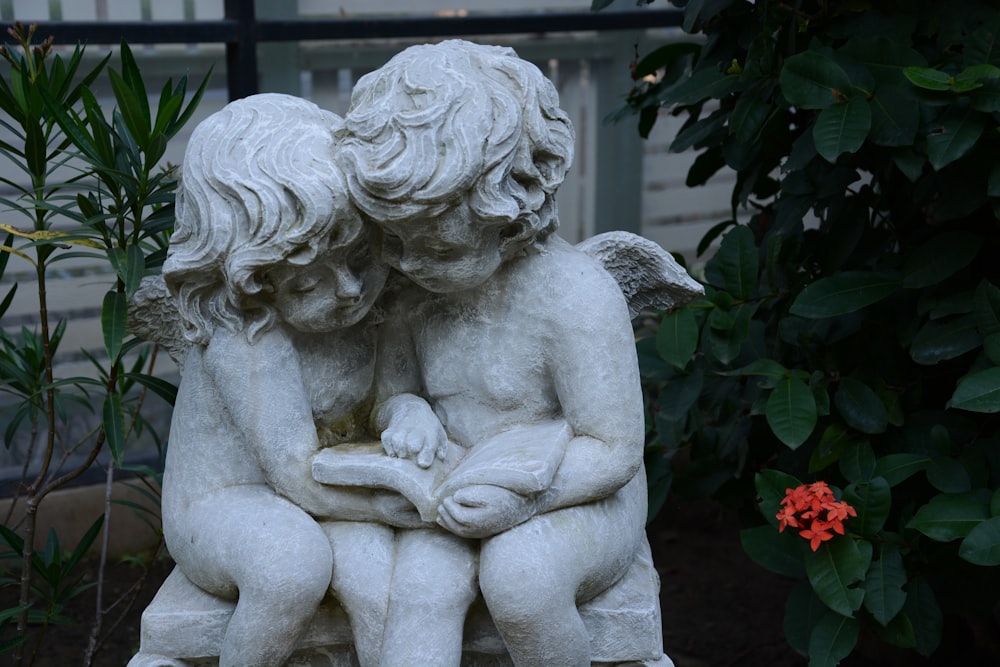 woman statue near red flower