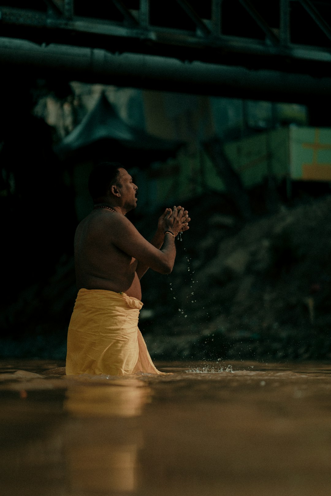 man in yellow shorts blowing bubbles