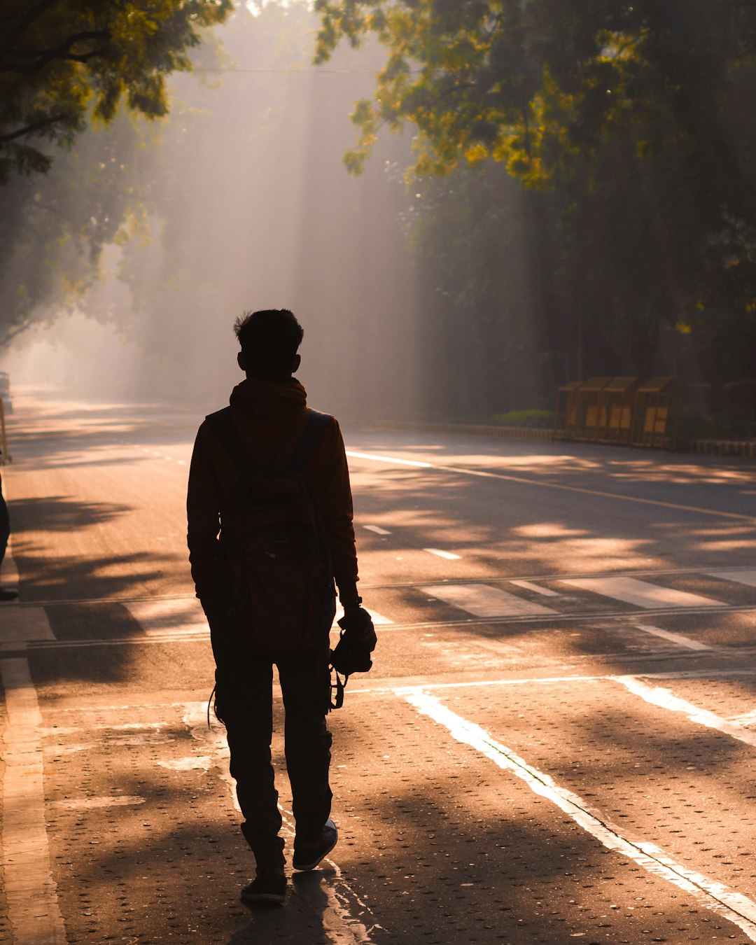 man in black jacket standing on road during daytime